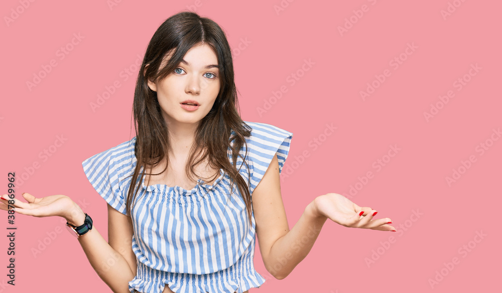 Young beautiful caucasian girl wearing casual clothes clueless and confused with open arms, no idea concept. Young beautiful caucasian girl wearing casual clothes clueless and confused with open arms, no idea concept.