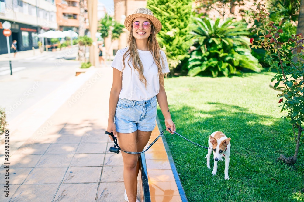 Εκτύπωση καμβά Young beautiful blonde woman walking the dog outside on a summer day