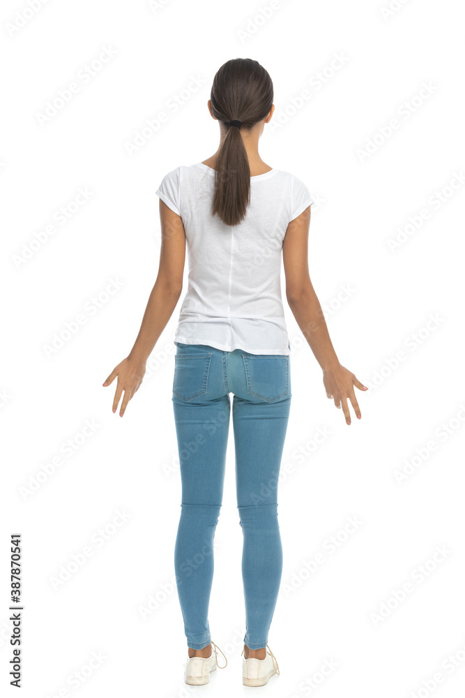 Back view of casual woman being surprised, standing Back view of casual woman being surprised, standing