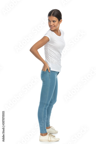 Side view of happy casual woman looking over shoulder