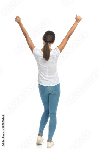Back view of casual woman celebrating and standing