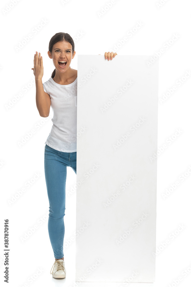 Furious casual woman holding blank billboard and yelling Furious casual woman holding blank billboard and yelling