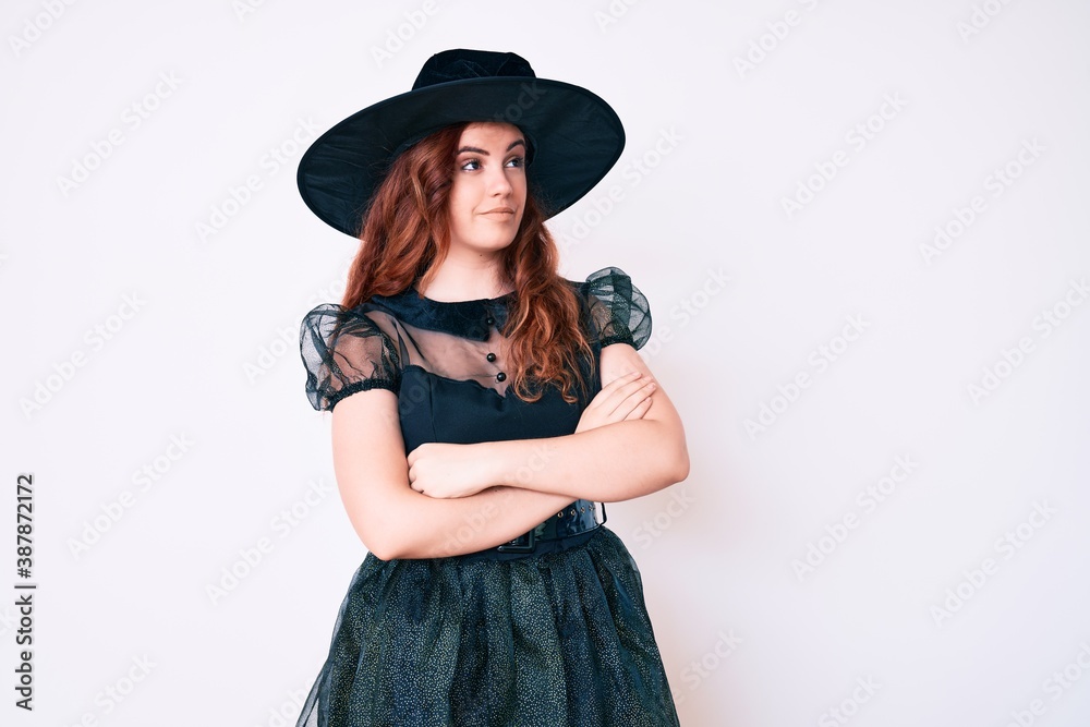Young beautiful woman wearing witch halloween costume looking to the side with arms crossed convinced and confident Young beautiful woman wearing witch halloween costume looking to the side with arms crossed convinced and confident
