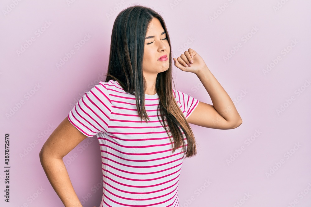 Young brunette woman wearing casual clothes over pink background stretching back, tired and relaxed, sleepy and yawning for early morning Young brunette woman wearing casual clothes over pink background stretching back, tired and relaxed, sleepy and yawning for early morning