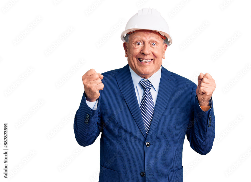 Senior handsome grey-haired man wearing suit and architect hardhat excited for success with arms raised and eyes closed celebrating victory smiling. winner concept. Senior handsome grey-haired man wearing suit and architect hardhat excited for success with arms raised and eyes closed celebrating victory smiling. winner concept.