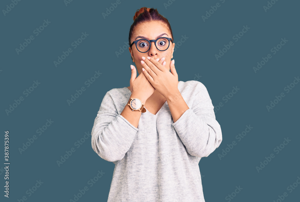 Young latin woman wearing casual clothes shocked covering mouth with hands for mistake. secret concept. Young latin woman wearing casual clothes shocked covering mouth with hands for mistake. secret concept.