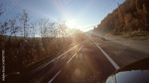 Man riding sportster motorcycle during sunset. photo