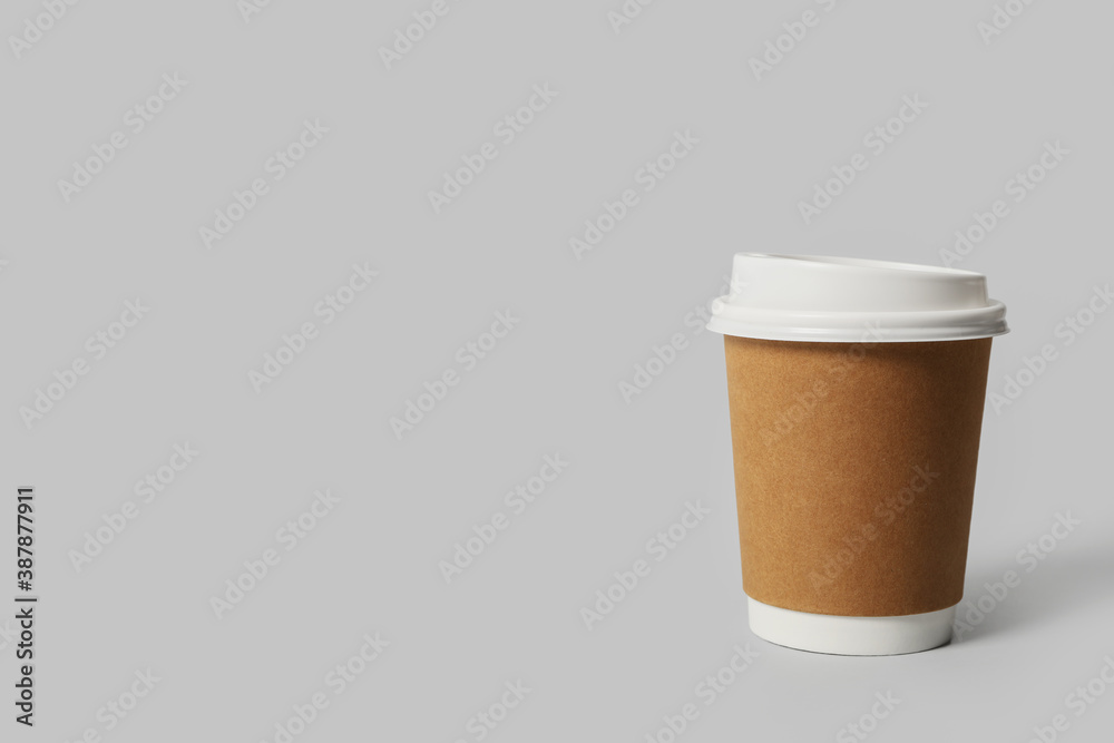 Takeaway paper coffee cup on light grey background. Space for text Takeaway paper coffee cup on light grey background. Space for text