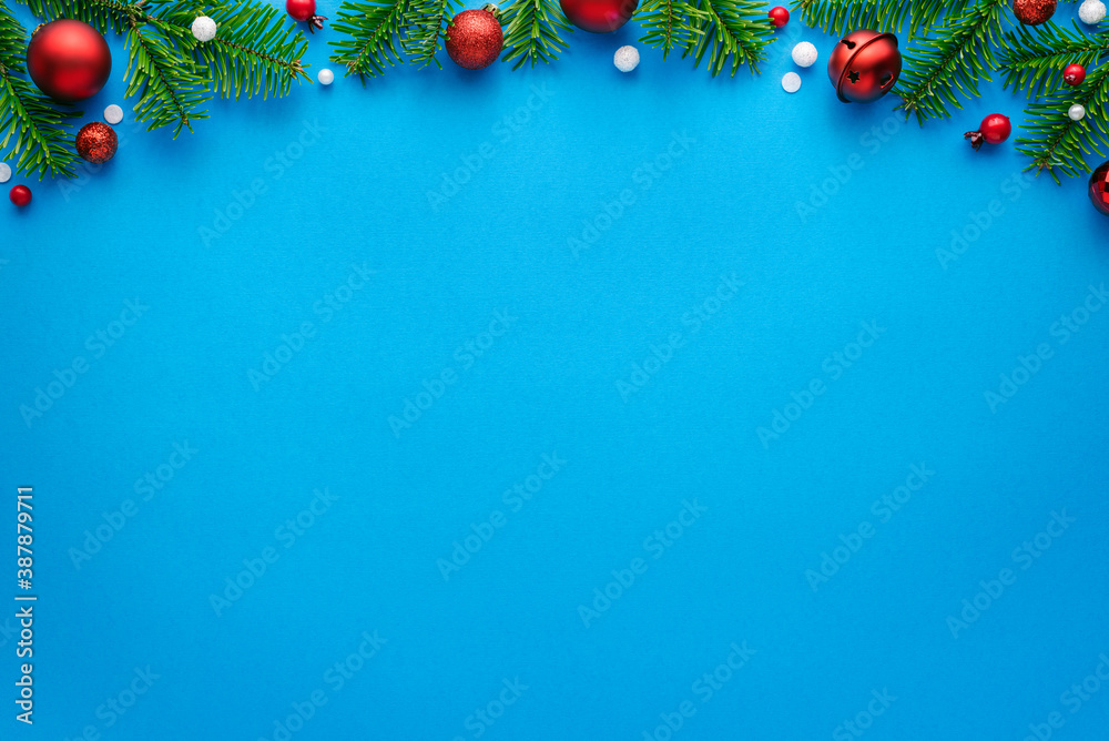 Christmas card with fir decorations on a blue background and copy space for festive text