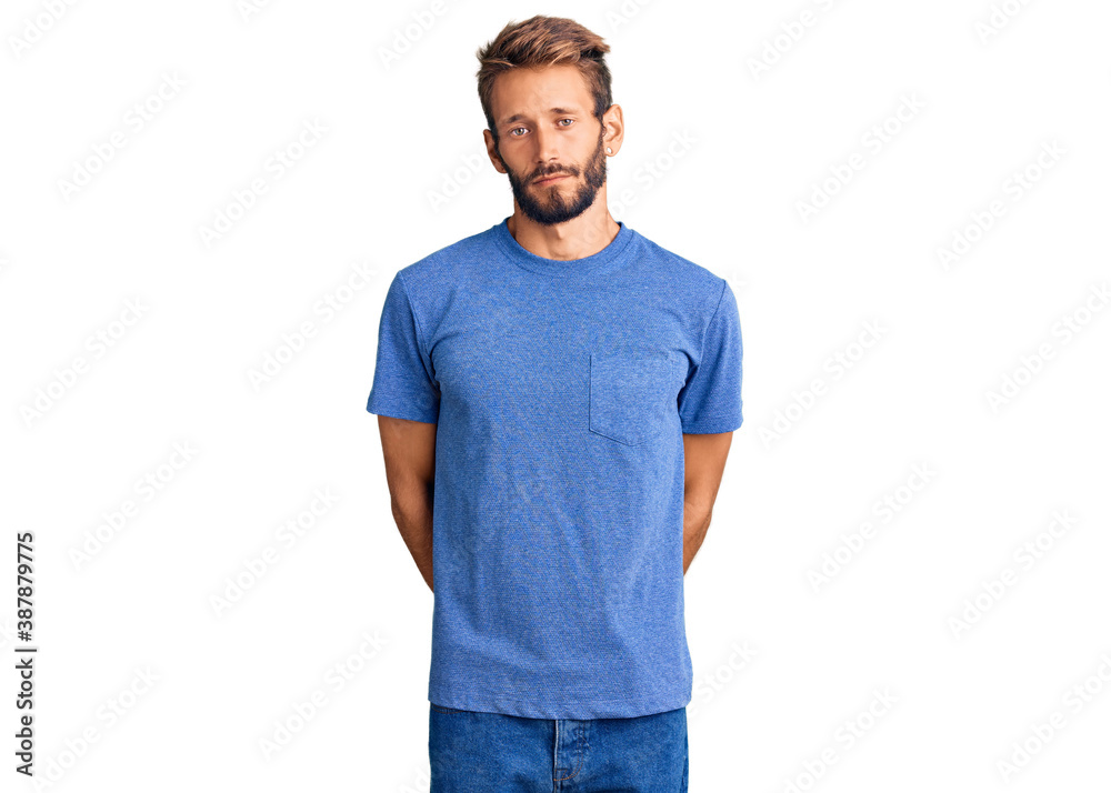 Handsome blond man with beard wearing casual clothes with serious expression on face. simple and natural looking at the camera. Handsome blond man with beard wearing casual clothes with serious expression on face. simple and natural looking at the camera.