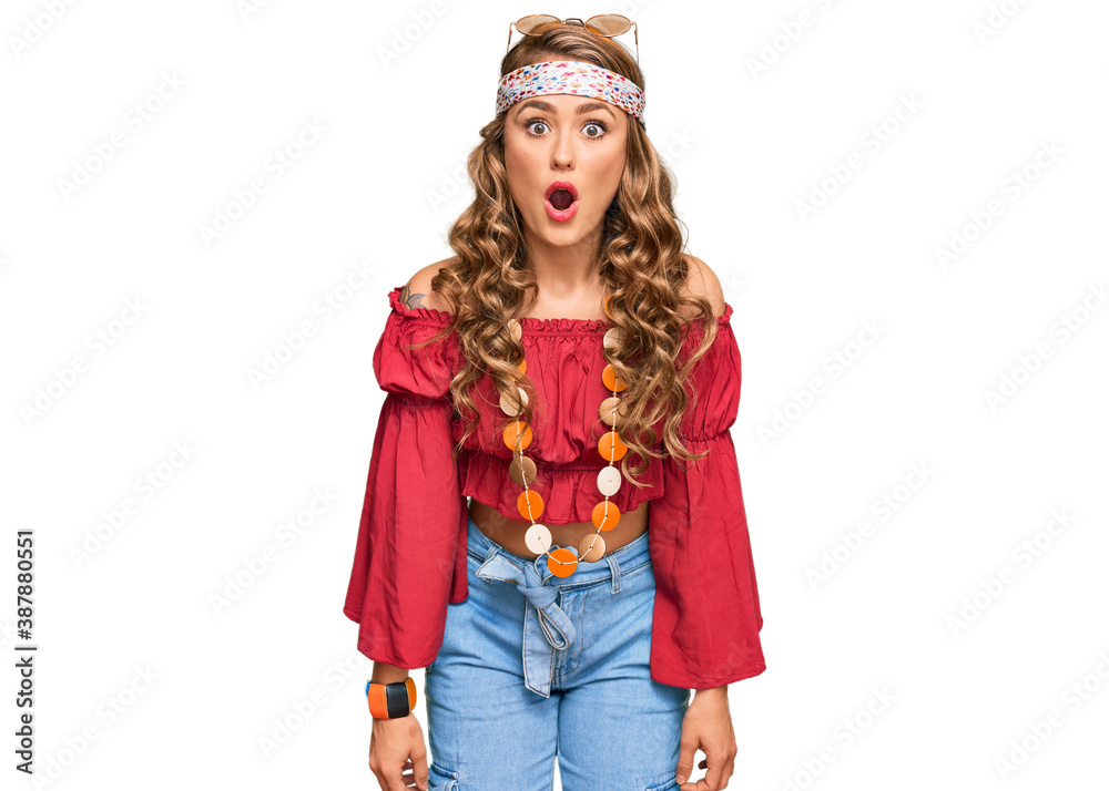 Young blonde girl wearing bohemian and hippie style scared and amazed with open mouth for surprise, disbelief face