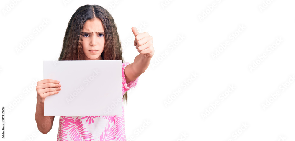 Cute hispanic child girl holding blank empty banner annoyed and frustrated shouting with anger, yelling crazy with anger and hand raised Cute hispanic child girl holding blank empty banner annoyed and frustrated shouting with anger, yelling crazy with anger and hand raised