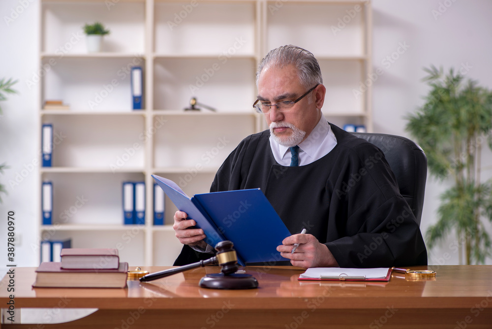 Old male judge working in courthouse Old male judge working in courthouse