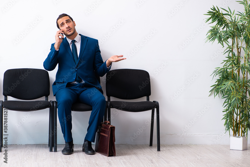 Young businessman waiting for an interview at hall Young businessman waiting for an interview at hall