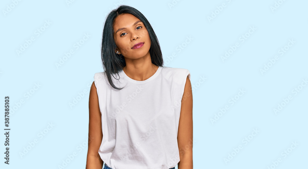 Young african american woman wearing casual clothes relaxed with serious expression on face. simple and natural looking at the camera.