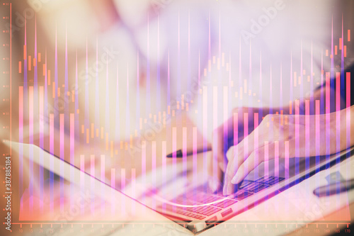 Fotografía Double exposure of woman hands typing on computer and forex chart hologram drawing
