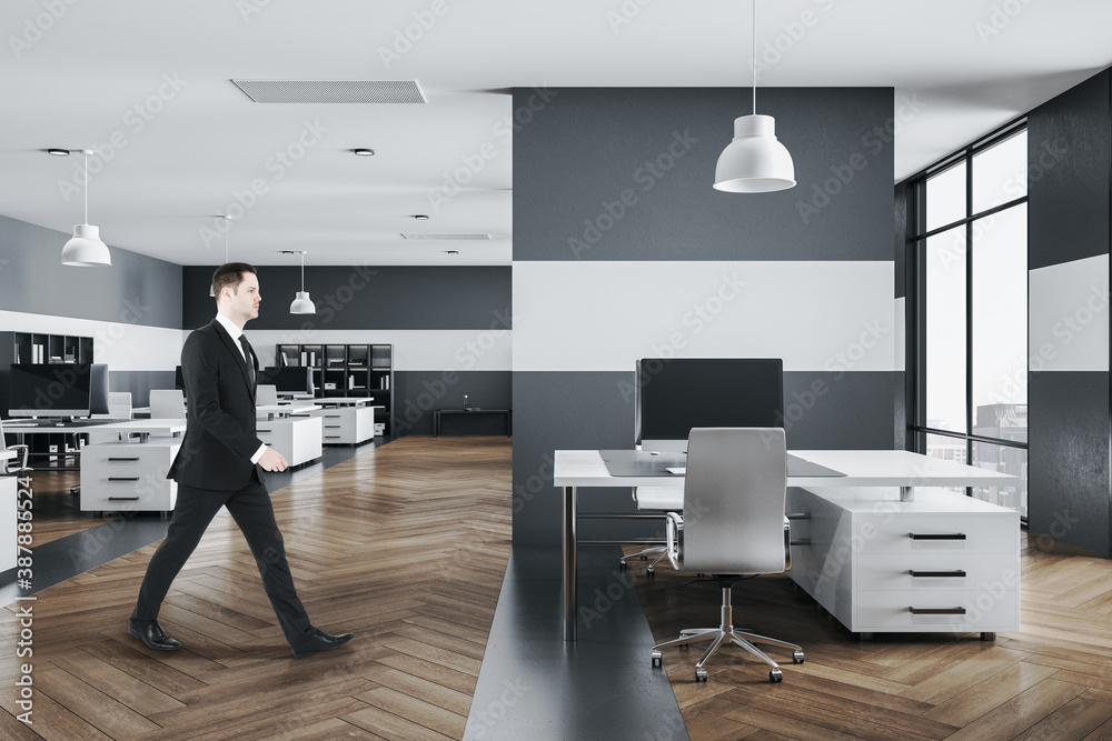 Businessman walking in modern office interior - obrazy, fototapety, plakaty 