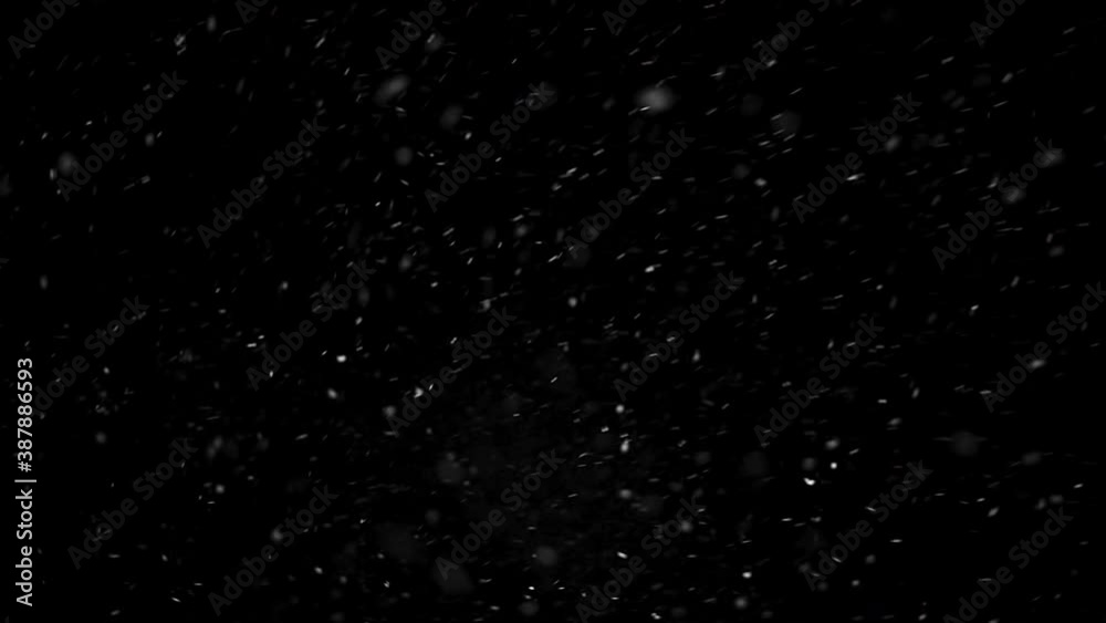 Real falling snow isolated on black background for composing, snowflakes bokeh falling during in snowstorm, snowing footage. Winter background. 4K video, winter, selective focus, blur