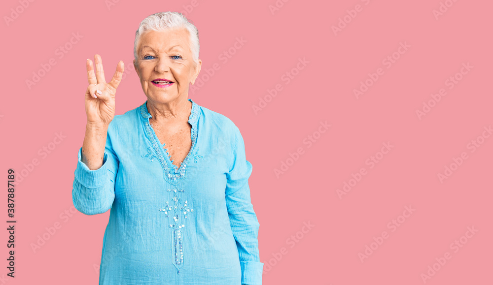 Senior beautiful woman with blue eyes and grey hair wearing summer dress showing and pointing up with fingers number three while smiling confident and happy. Senior beautiful woman with blue eyes and grey hair wearing summer dress showing and pointing up with fingers number three while smiling confident and happy.