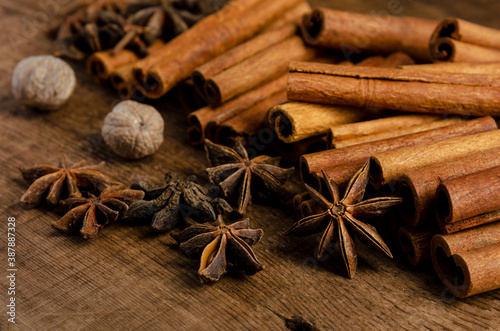 Cinnamon, anise, nutmeg, on dark wooden background