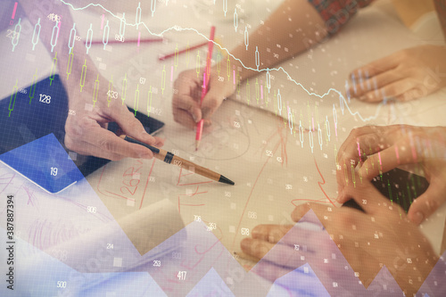 Double exposure of forex graph drawing and man and woman working together holding and using a mobile device. Trade concept.