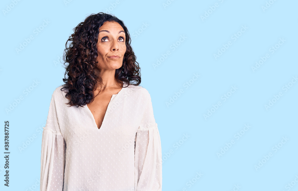 Middle age beautiful woman wearing casual sweater smiling looking to the side and staring away thinking. Middle age beautiful woman wearing casual sweater smiling looking to the side and staring away thinking.