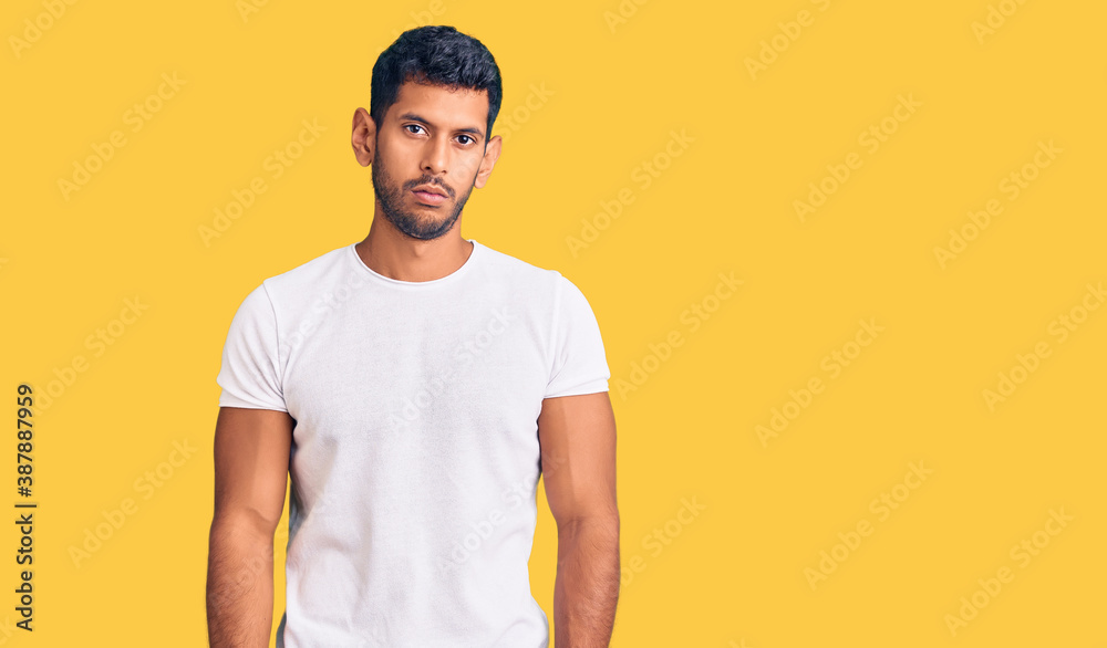 Young latin man wearing casual clothes relaxed with serious expression on face. simple and natural looking at the camera. Young latin man wearing casual clothes relaxed with serious expression on face. simple and natural looking at the camera.