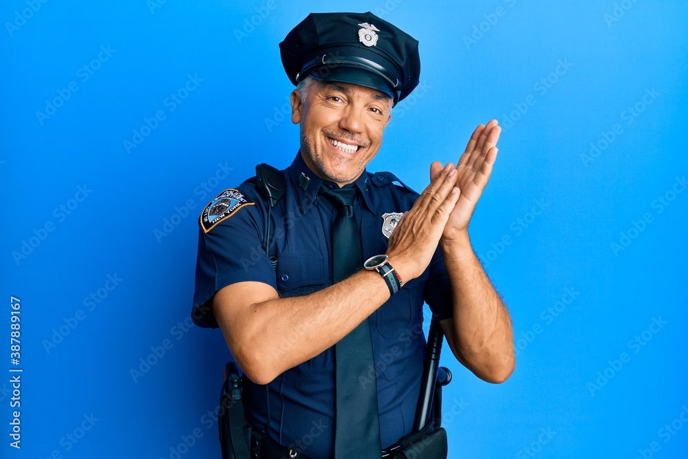 Handsome middle age mature man wearing police uniform clapping and applauding happy and joyful, smiling proud hands together Handsome middle age mature man wearing police uniform clapping and applauding happy and joyful, smiling proud hands together