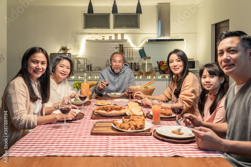 Portrait of Asian big family having dinner party in the kitchen.