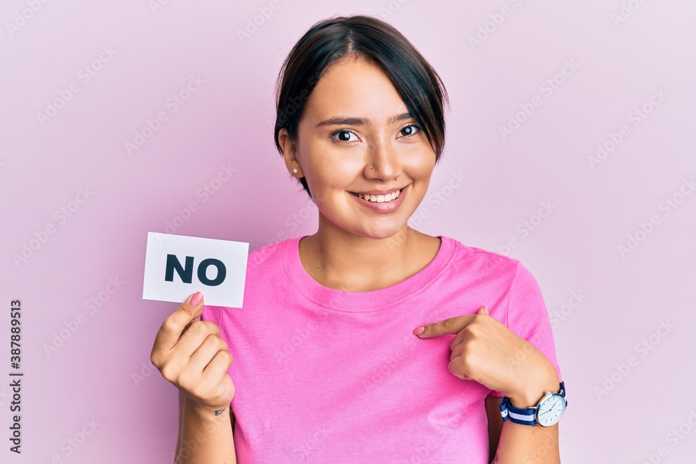 Beautiful young woman with short hair holding no word message pointing finger to one self smiling happy and proud