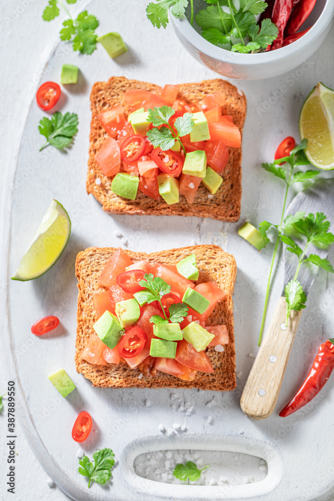 Homemade Toast made of tomatoes, chilli pepper and avocado Homemade Toast made of tomatoes, chilli pepper and avocado