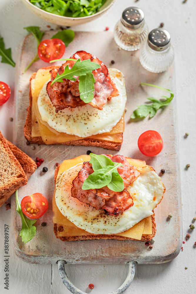 Homemade toast with egg, bacon and cherry tomato