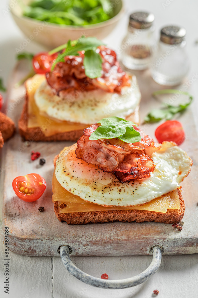 Tasty toast with egg, bacon and cherry tomato Tasty toast with egg, bacon and cherry tomato