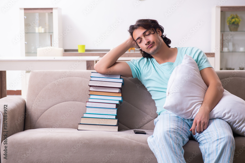 Young male student being tired preparing for exams at home Young male student being tired preparing for exams at home