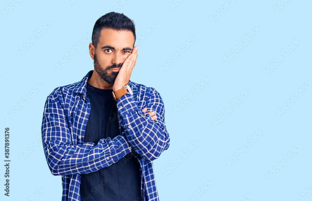 Young hispanic man wearing casual clothes thinking looking tired and bored with depression problems with crossed arms.