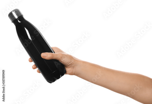 Woman holding black thermos bottle on white background, closeup
