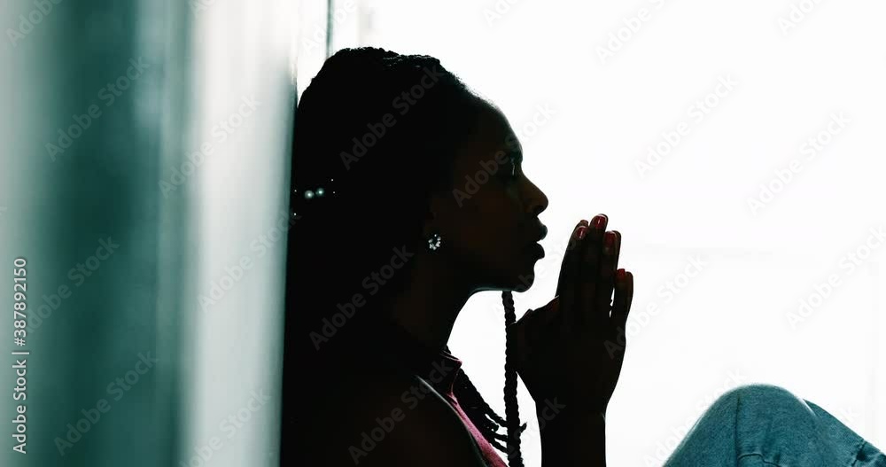 African woman praying with HOPE and FAITH