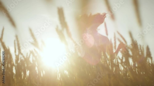 A girl in a white dress is running on the filed
