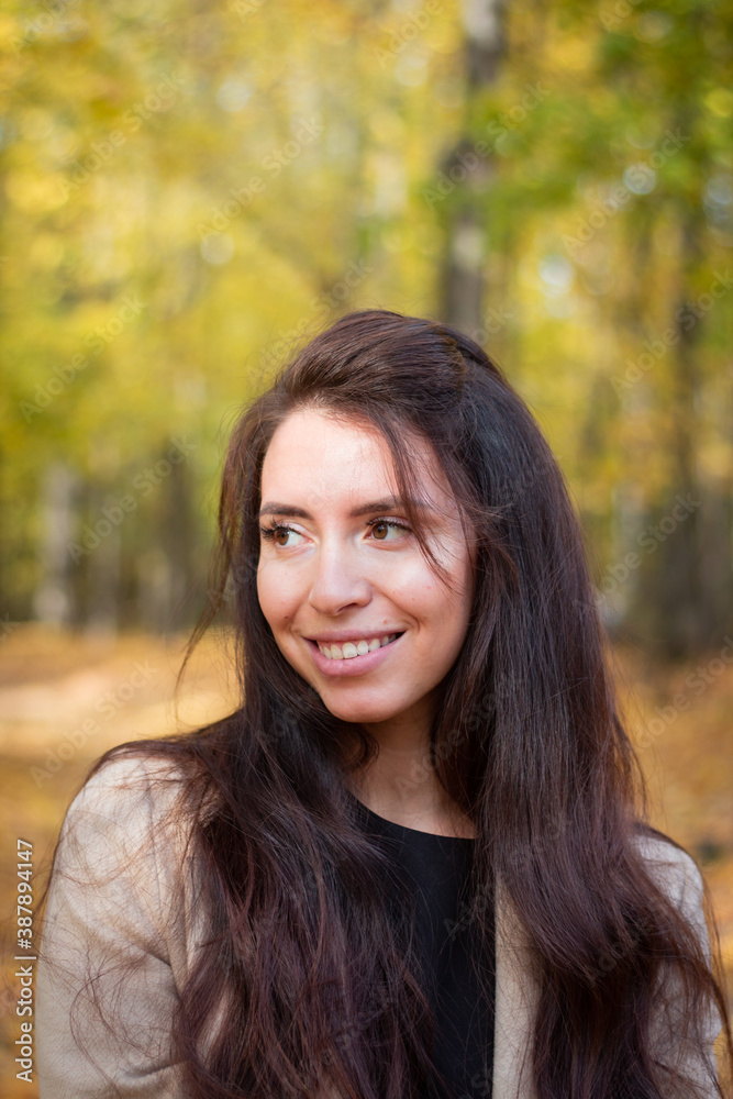Brunette woman in autumn park. Close plan. Smiling woman. Autumn mood. Beautiful brunette. Brunette woman in autumn park. Close plan. Smiling woman. Autumn mood. Beautiful brunette.