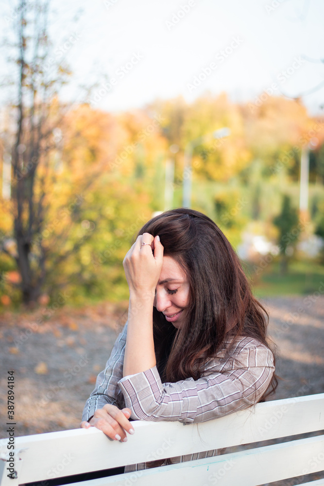 Brunette woman in autumn park. Close plan. Smiling woman. Autumn mood. Beautiful brunette. Brunette woman in autumn park. Close plan. Smiling woman. Autumn mood. Beautiful brunette.