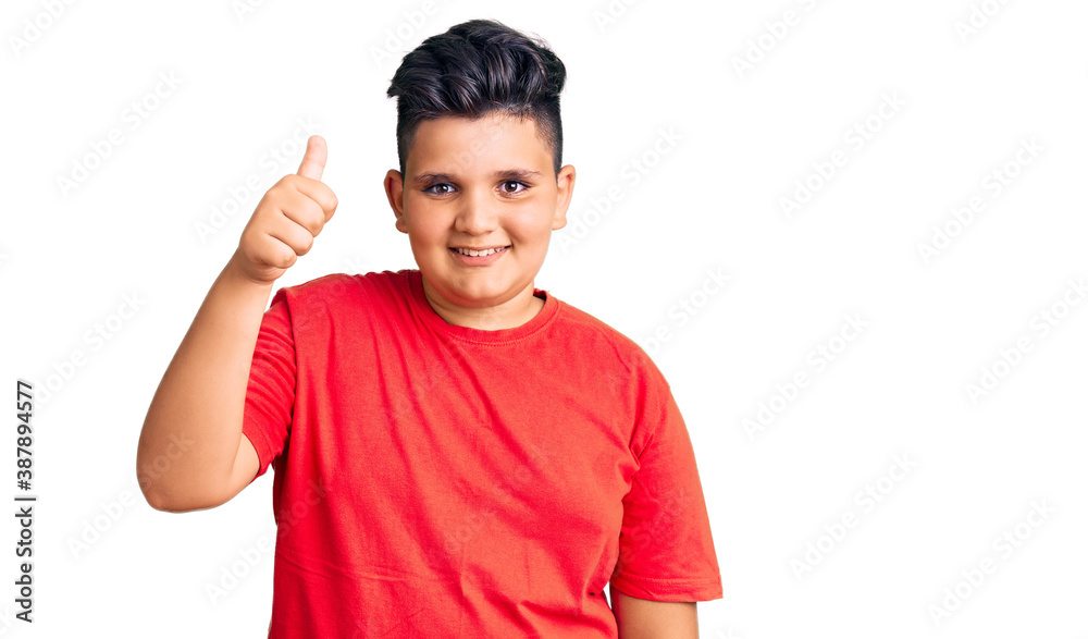 Little boy kid wearing casual clothes smiling happy and positive, thumb up doing excellent and approval sign Little boy kid wearing casual clothes smiling happy and positive, thumb up doing excellent and approval sign