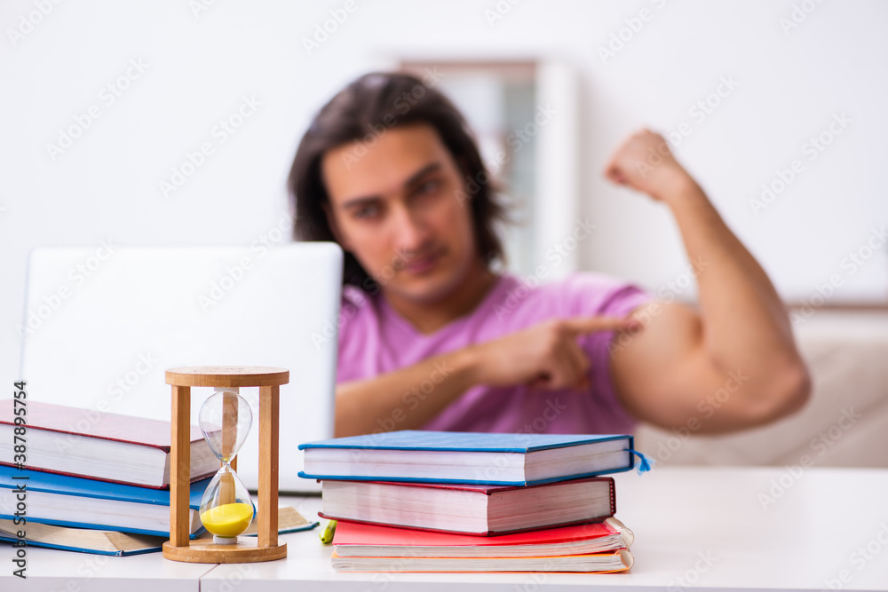 Male student in love preparing for exams in time management conc Male student in love preparing for exams in time management conc