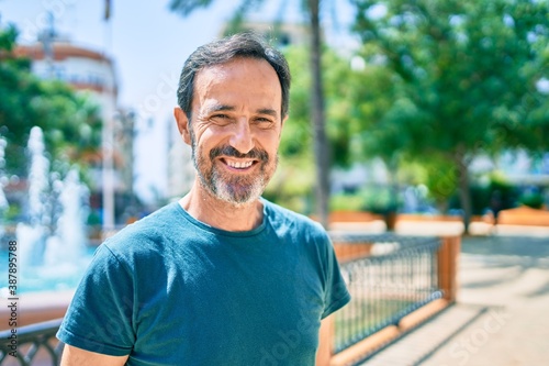 Middle age man with beard smiling happy outdoors