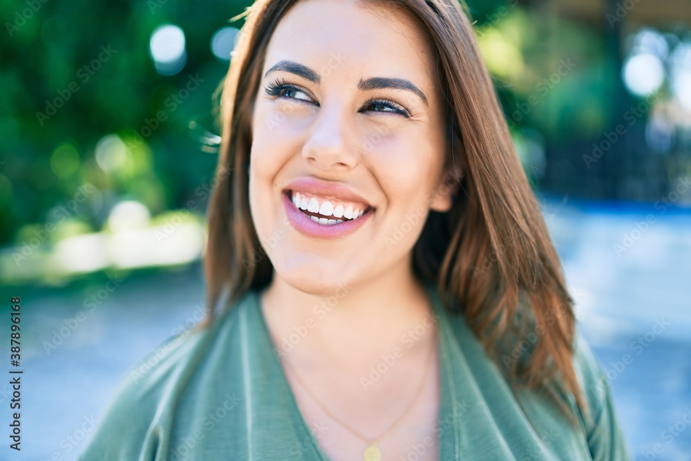 Young hispanic woman smiling happy walking at street of city Young hispanic woman smiling happy walking at street of city