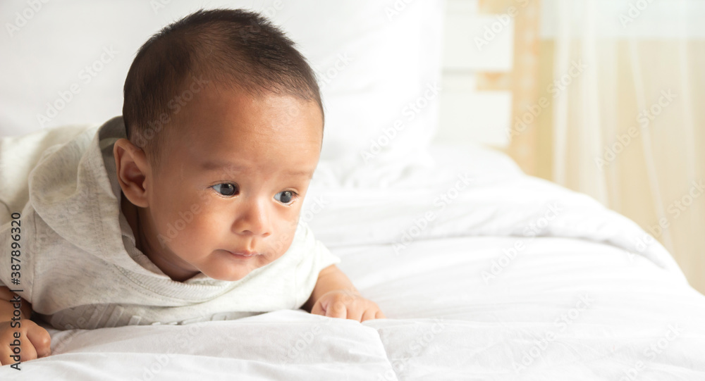 Portrait of happy smile baby relaxing on the bed Portrait of happy smile baby relaxing on the bed