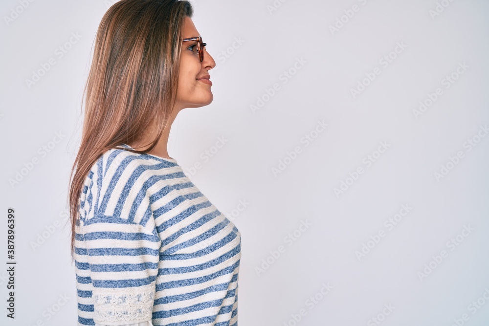 Beautiful caucasian woman wearing casual clothes and glasses looking to side, relax profile pose with natural face with confident smile. Beautiful caucasian woman wearing casual clothes and glasses looking to side, relax profile pose with natural face with confident smile.