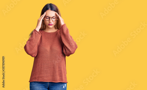 Beautiful young woman wearing casual clothes and glasses with hand on head for pain in head because stress. suffering migraine. © Krakenimages.com