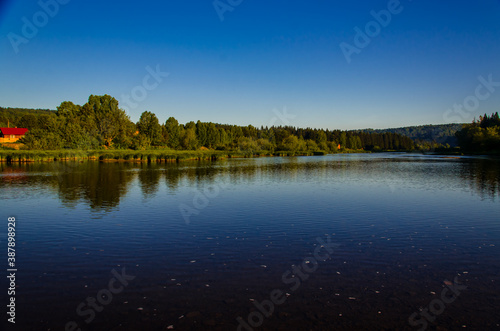 houses on the beach. Rural river in the early morning