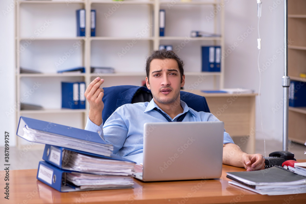 Young male employee suffering at workplace Young male employee suffering at workplace