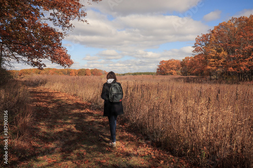 Autumn trail hiker walking through the colorful prairie